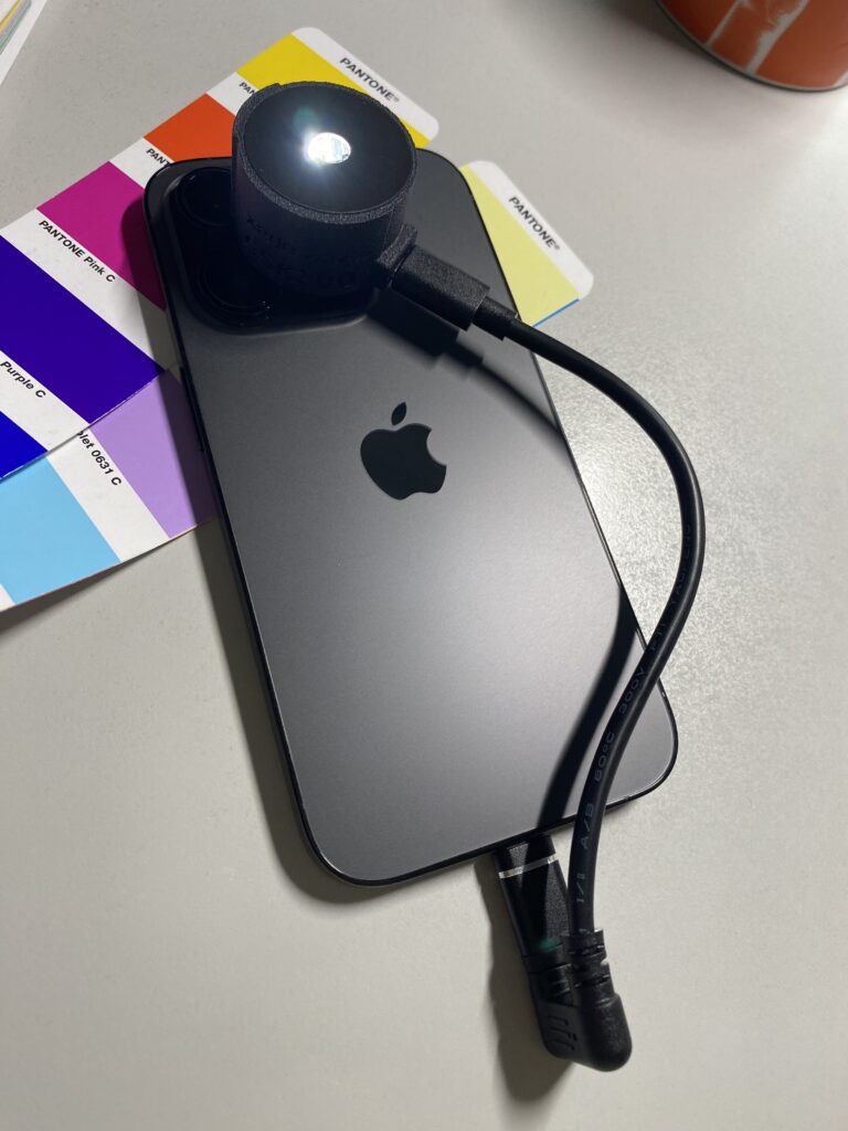 A xade nano egy iPhone 14 Pro készüléken. Jól látható a mérőfej, amely a Lightning vagy USB-C csatlakozón keresztül kap áramot.